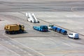 Airfield universal cleaning machine, pushback tug, passenger boarding steps vehicle, tractor with baggage carts and minivan Royalty Free Stock Photo