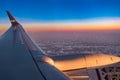 Airfoil, aerofoil of Fijian Airplane at sunset with orange and yellow stripe on  horizon and cloudy sky Royalty Free Stock Photo