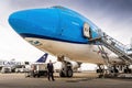 Airline captain in front of big airplane. Pilot standing next to a Boeing 747. Airplane with captain.