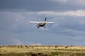An Airplane Lands Over African Animals At Maasai Mara National Park