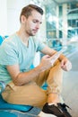 Young man in an airport lounge waiting for flight aircraft. Caucasian man with smartphone in the waiting room Royalty Free Stock Photo