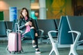 Airline passenger in an airport lounge waiting for flight aircraft. Caucasian woman with smartphone in the waiting room Royalty Free Stock Photo