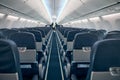 Airline passenger chairs and aisle in airplane cabin Royalty Free Stock Photo