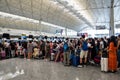 Airline passengers checking in at an airline counter at Hong Kong International Airport