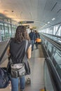 Airline passengers walking along the corridor in the departure terminal to their flight Royalty Free Stock Photo