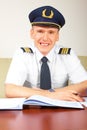 Airline pilot filling in papers in ARO Royalty Free Stock Photo