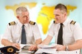 Airline pilots filling in papers in ARO Royalty Free Stock Photo