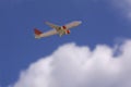 An airline plane in the blue sky flying above big white blurred clouds. Image with copy space Royalty Free Stock Photo