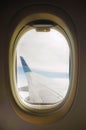 Airline window view, aircraft wing currently flying at the sky