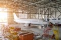 Airliner aircraft in a hangar with an open gate to the service. Royalty Free Stock Photo