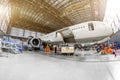 Airliner aircraft in a hangar to the service. Royalty Free Stock Photo