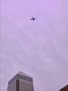 Airliner flying over Canary Wharf in London Royalty Free Stock Photo