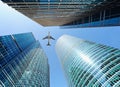 Airliner flying over skyscrapers Royalty Free Stock Photo