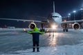 Airliner marshalling at the aiport apron at winter night Royalty Free Stock Photo