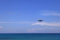 Airliner or Passenger plane AirAsia Airbus A320 landing to airport next to the beach.