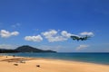 Airliner or Passenger plane Emirates Boeing 777-300ER landing to airport next to the beach.