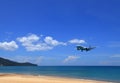 Airliner or Passenger plane Emirates Boeing 777-300ER landing to airport next to the beach.