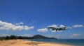 Airliner or Passenger plane Emirates Boeing 777-300ER landing to airport next to the beach.