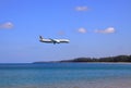 Airliner or Passenger plane Etihad Boeing 787-8 landing to airport next to the beach.