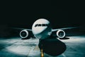 Airliner plane parked at the terminal view from the front cockpit fuselage, on runway at night Royalty Free Stock Photo