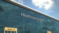Airliner take off reflecting in the windows with Heathrow Airport text, 3d rendering