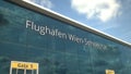 Commercial plane take off reflecting in the windows with Flughafen Wien Schwechat or Vienna Airport text, 3d rendering