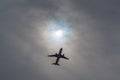 Airliner visible under a gash in the clouds Royalty Free Stock Photo