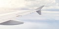 Airplain wing view thrue window in the sky. Clouds sky, airplane's wing through porthole of aircraft Royalty Free Stock Photo