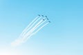Airplains and smoke trails in the bright blue sky. Royalty Free Stock Photo