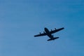 Military transport airplane flying at a low altitude Royalty Free Stock Photo