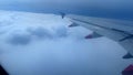 Airplane above clouds retracting ground spoilers