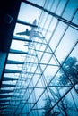 Airplane above the glass building Royalty Free Stock Photo