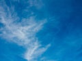 Airplane against the background of a blue sky with light rare clouds. Flight