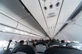 Airplane air conditioning control panel over seats. Stuffy air in aircraft cabin with people. New low-cost airline