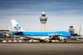 Airplane with air traffic control tower. Boeing 747 landing at an airport. Jumbo jet with reverse thrust Royalty Free Stock Photo