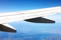 An airplane in the air. Airplane wing with view of mountains underneath, from the plane window. The wing aircraft in Royalty Free Stock Photo