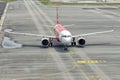 Airplane by AirAsia airline at airport, front view