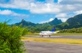 Airplane at the airport on the background mountain landscape, Rarotonga, Aitutaki, Cook Islands. Copy space for text
