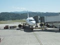 Airplane at airport with passenger boarding bridge.