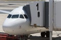 Airplane at an Airport With Passenger Gangway Royalty Free Stock Photo