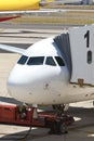 Airplane at an Airport With Passenger Gangway Royalty Free Stock Photo