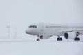 Airplane at airport during snowfall Royalty Free Stock Photo