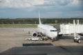 Airplane at airport terminal gate ready for takeoff. Modern international airport. Royalty Free Stock Photo