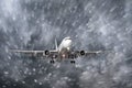 Airplane approaching on a landing in snowstorm bad weather. Royalty Free Stock Photo