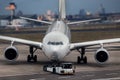 Airplane beeing towed at an airport composing