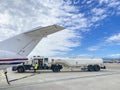 Airplane being refueled, fuel truck at the airport