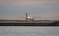 Airplane belonging to Porter Airlines illuminated in the golden light of the setting sun