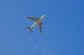 Airplane from below. Airplane against blue sky. Royalty Free Stock Photo