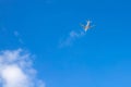Airplane in the blue sky. Airliner is gaining altitude. White cloud in the blue sky in which the plane flies. Royalty Free Stock Photo