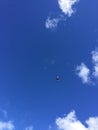 Airplane in blue sky surrounded by white clouds